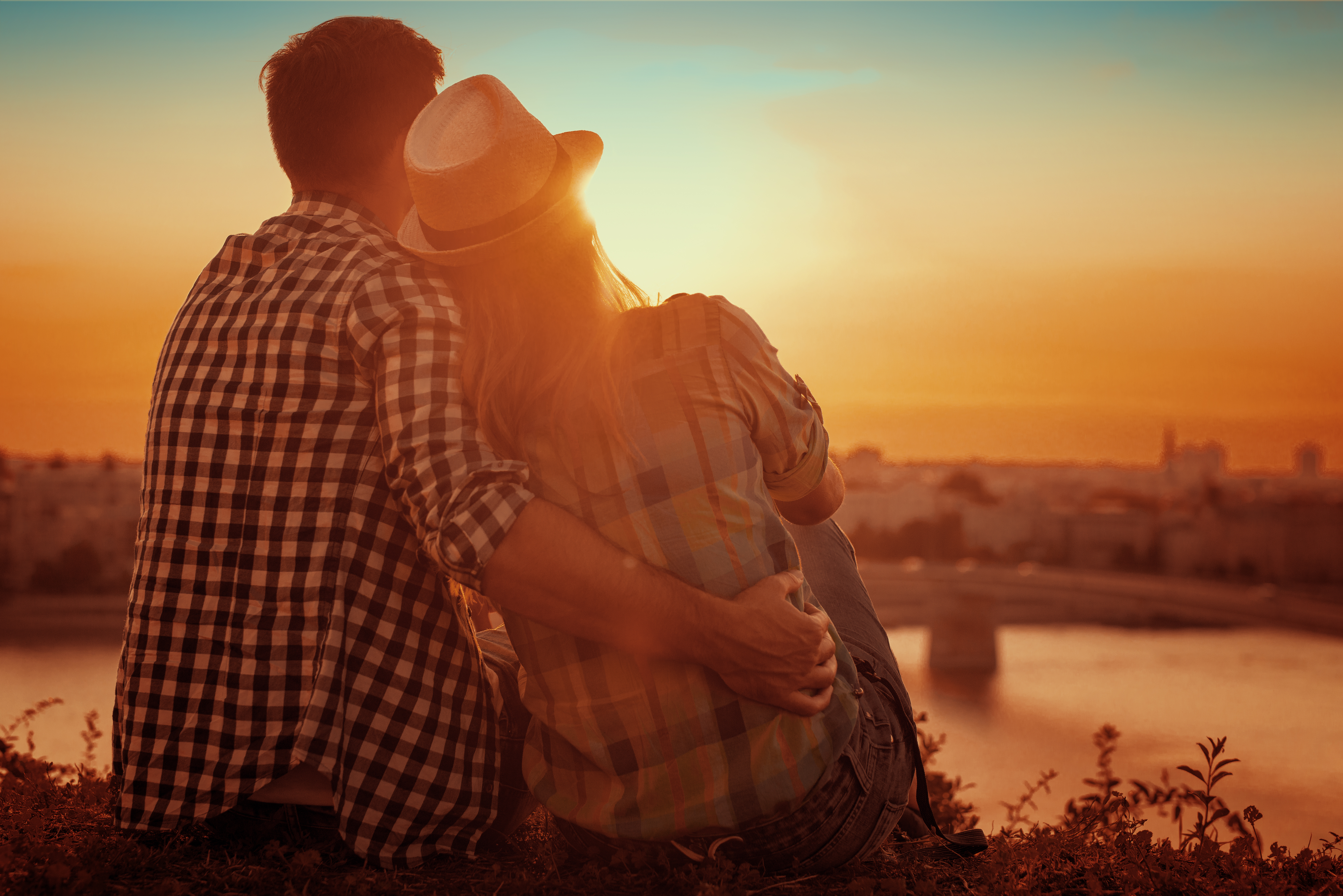 Happy couple hugging on the beach on sunrise