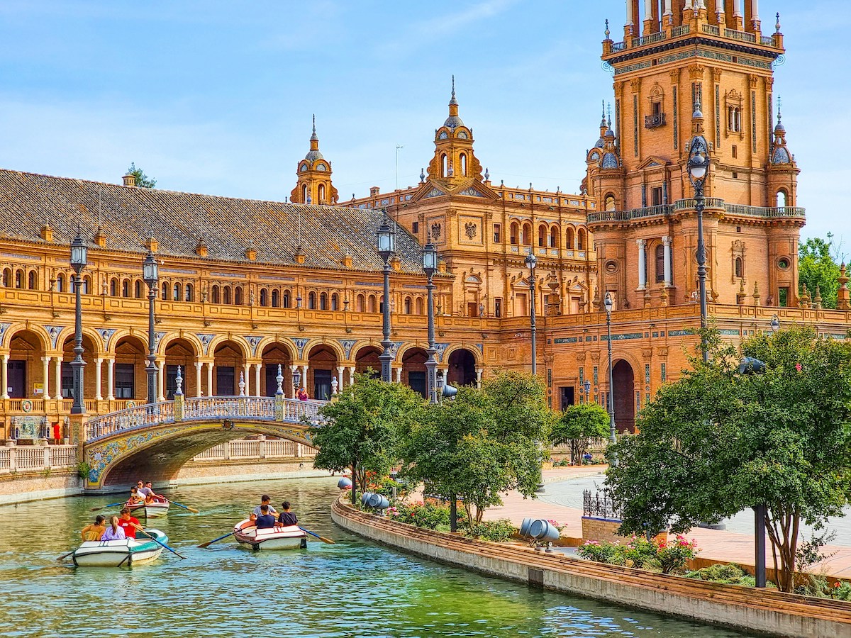 People in row boats exploring Seville, Spain