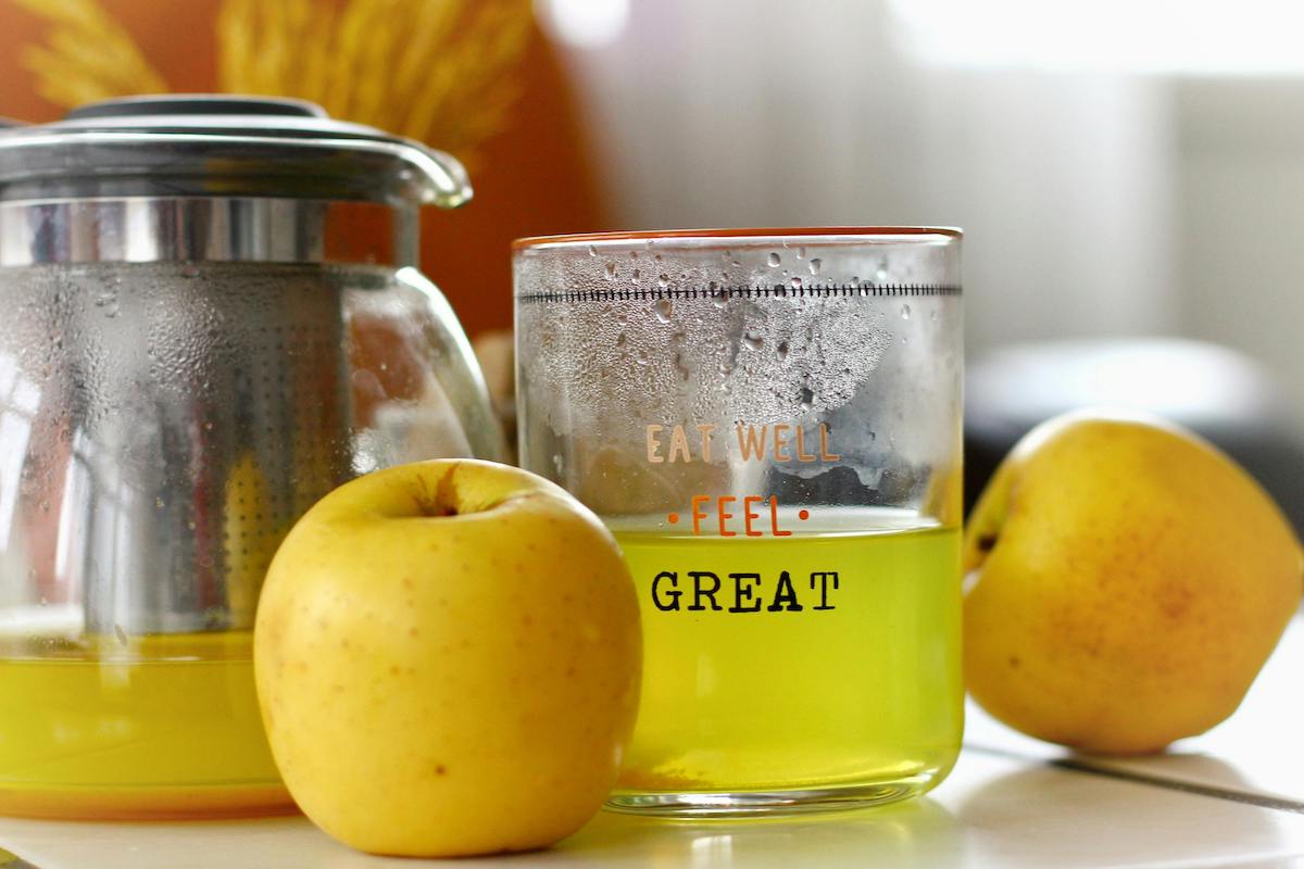 Fresh Apple Juice and Steaming Teapot Close-up